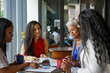 © Mhandy/Creative Flame - Women having a business meeting in cafe