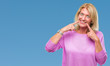 © Krakenimages.com - Middle age blonde woman over isolated background smiling confident showing and pointing with fingers teeth and mouth. Health concept.