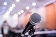 © nattanan - Microphone over the blurred business forum Meeting or Conference Training Learning Coaching Room Concept, Blurred background.