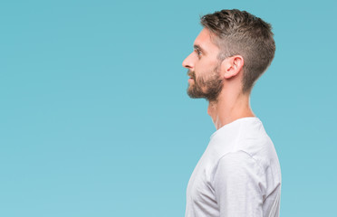 Wall Mural - Young handsome man over isolated background looking to side, relax profile pose with natural face with confident smile.