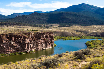 Canvas Print - The Green River passes red-brown rock cliffs, wetlands, wide prairies, and mountains in Browns Park National Wildlife Refuge in northwestern Colorado