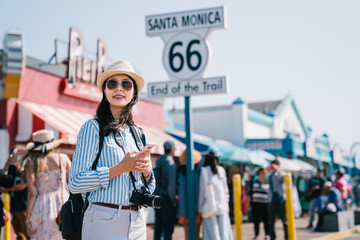 Canvas Print - tourist standing next to the sign of santa monica