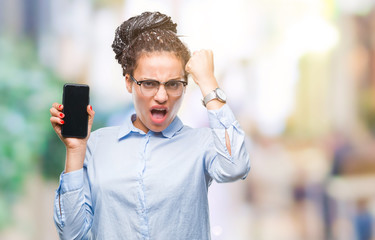 Sticker - Young braided hair african american business girl showing screen of smartphone over isolated background annoyed and frustrated shouting with anger, crazy and yelling with raised hand, anger concept