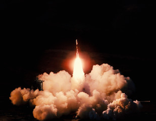 Wall Mural - launch of the spaceship from the spaceport at night. flight of space shuttle in clouds of smoke. som