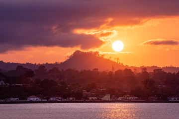 Sunset over Sao Tome Nature landscape of Sâo Tomé and Principe. Mountains like Pico Cão Grande. Travel to Sao Tome and Principe. Beautiful paradise island in Gulf of Guinea. Former colony of Portugal.