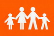 © yurolaitsalbert - happy paper family on a bright orange background.