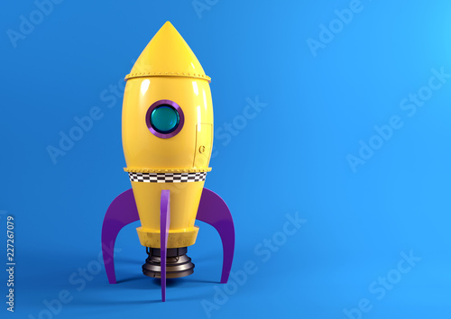 Cuadros en Lienzo A retro yellow toy spaceship rocket set against a blue background ready to launch