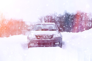 The car stands on a snow-covered road