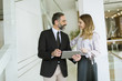 © BGStock72 - Young businesswoman and businessman look on digital tablet and discuss aout project