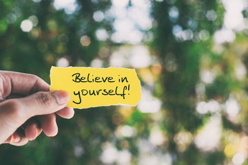 Wall Mural - Inspirational quote on piece of paper - Believe in yourself.