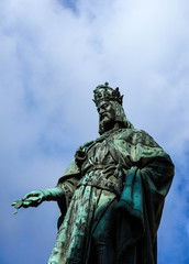 Statue of King Charles, Prague, on a blue sky background. Monument sculpture of the Czech King Charles 4