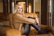 © nagaets - nice girl is resting on the big armchair