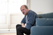 © SB Arts Media - Depressed overwhelmed old man feeling exhausted alone and unhappy suffering from depression