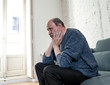 © SB Arts Media - Depressed overwhelmed old man feeling exhausted alone and unhappy suffering from depression