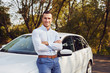 © Rostislav Sedlacek - A smiling man with crossed arms stands in front of his new car