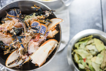 Wall Mural - Colorful lobsters in a silver bowl next to bay leaves