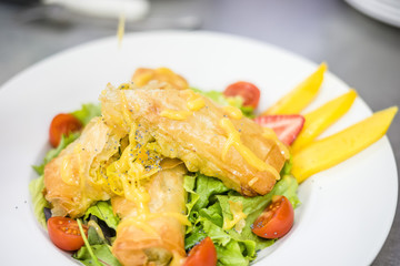 Wall Mural - Sea food croquettes served with lettuce, cherry tomatoes and mango