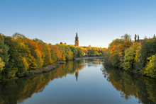 Beautiful Fall Foliage And Aura River Against Clear Blue Sky With Turku Cathedral In Background In Turku, Finland, Autumn 2018