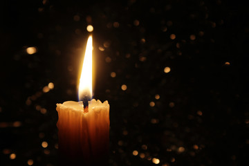 Candles Burning at Night. White Candles Burning in the Dark with focus on single candle in foreground. 