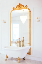 Vintage White Color Bathroom Near Mirror With A Golden Frame. Art Deco. Luxury Interior