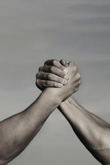 Rivalry, vs, challenge, strength comparison. Two men arm wrestling. Arms wrestling, competition. Rivalry concept - close up of male arm wrestling. Leadership concept. Black and white.