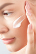© Mirrorstudio - Young beautiful woman applies cream on clean perfect skin