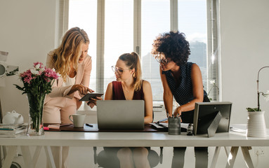 Wall Mural - Group of businesswomen working together in office