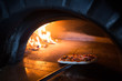 © Luis Garcia - Making pizza in a wood fired oven.