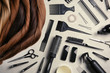 Flat lay composition with different locks of hair and tools on color background