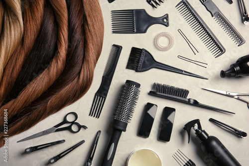 Fotografía Flat lay composition with different locks of hair and tools on color background