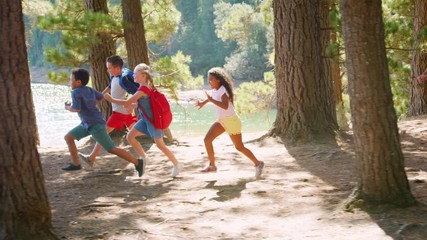 Wall Mural - Children Running Ahead Of Parents On Family Hiking Adventure 