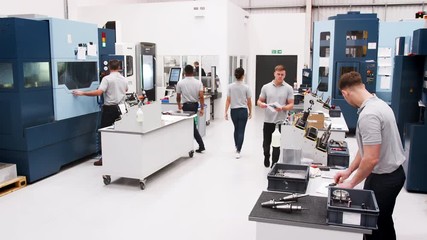 Wall Mural - busy engineering workshop with workers using cnc machinery