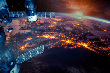 Wall Mural - atlantic coast of the united states night lights and sunrise with lens flare from the space station.