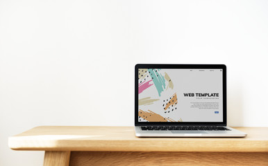 Wall Mural - laptop showing website template on a wooden table