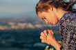 © PhotoGranary - Christian worship and praise. A young woman is praying in the evening.