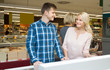 © caftor - Positive young couple shopping in supermarket