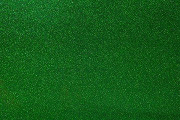 Abstract green glitter texture background. Glowing shiny paper for warp your gift box or party decoration.