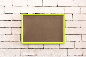 Poster - Hanging colorful photo frame on brick wall in loft concept style. Blank vivid border for your design or show at gallery room.