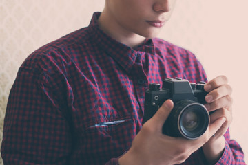 close up young person hands holding a vintage camera  f