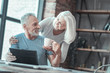 Than you. Nice happy aged man looking at his wife and smiling while taking a cup of tea