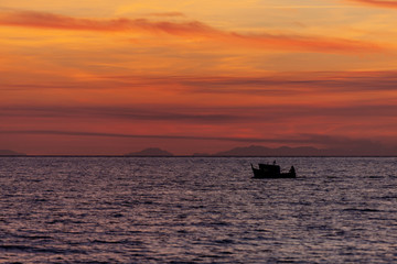 Wall Mural - Fishing boat come back from fishing at sunset, Italy