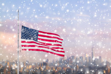 American Flag And Blurred Skyline Of Manhattan In The Snowfall. New York City. Winter Concept. 