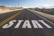 © Syda Productions - new beginnings, travel and adventure concept - close up of word start on suburban asphalt road