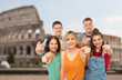 © Syda Productions - travel, tourism and vacation concept - group of happy smiling friends pointing at you over coliseum background