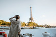 © rh2010 - Young woman enjoying beautiful landscape view on the riverside with Eiffel tower from the boat during the sunset in Paris