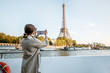 © rh2010 - Young woman enjoying beautiful landscape view on the riverside with Eiffel tower from the boat during the sunset in Paris