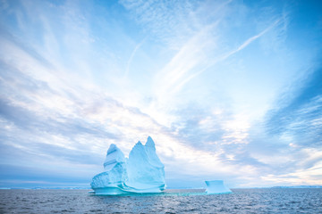 Wall Mural - photogenic and intricate iceberg under an interesting and colorful sky during sunset. disko bay, gre