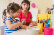 © very_ulissa - granddaughter doing handycraft together with her grandmother in nursery, improvement of fine motor skills