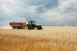 © Cavan for Adobe - Woman driving tractor on wheat field