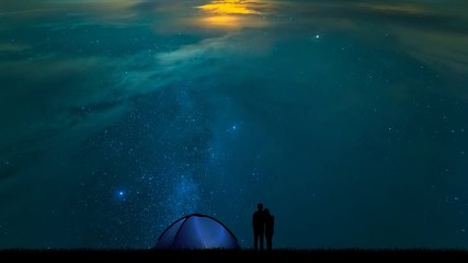 Wall Mural - The man and a woman near a camping tent standing on a starry sky background